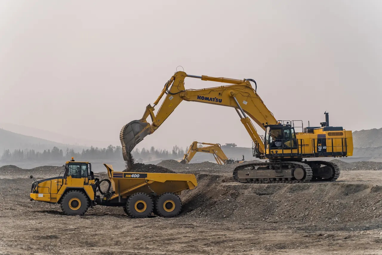 Komatsu excavator loading an articulated dump truck